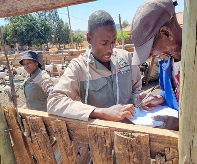Ms Hlokoe and Mr Mokoena explaining animal breeding to the farmer